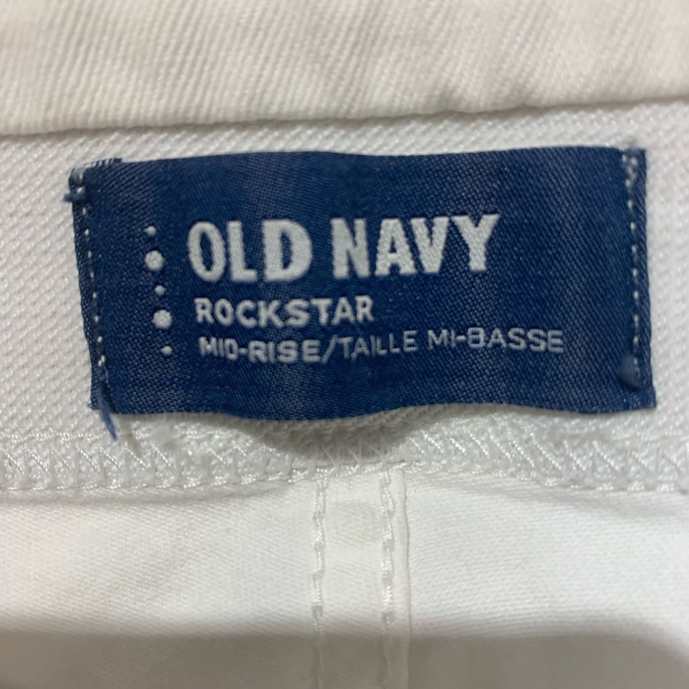 White stretchy jeans. High waisted. Bottoms hemmed.